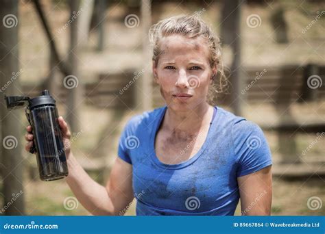 Portrait of Woman Holding Water Bottle during Obstacle Course Stock Photo - Image of activity ...