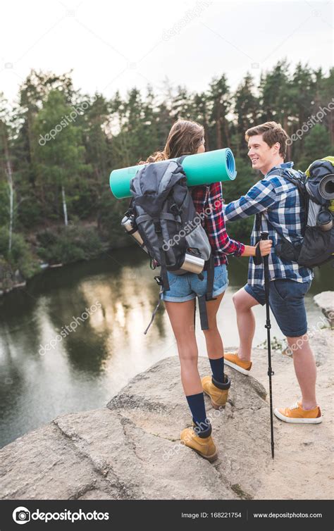 Couple with backpacks having hiking trip — Stock Photo © ArturVerkhovetskiy #168221754