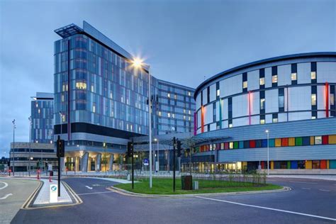 an office building with multicolored windows and lights on the side of ...