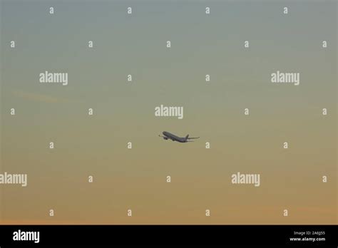 Airplane taking off in sunset Stock Photo - Alamy