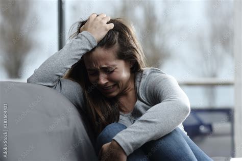 Sad girl complaining and crying at home Stock Photo | Adobe Stock