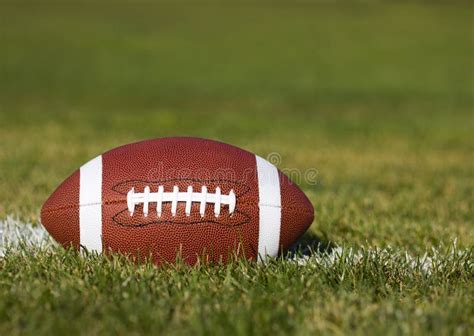 American Football on the Field with Green Grass Stock Photo - Image of object, marks: 33470162