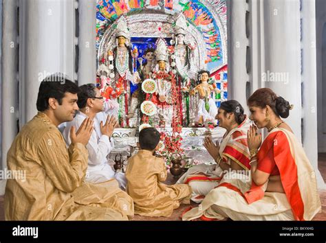 Family praying in a temple Stock Photo - Alamy