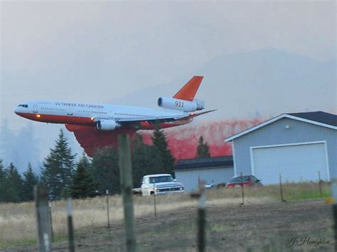 A DC-10 air tanker drops retardant on a brush fire near Spokane, WA ...