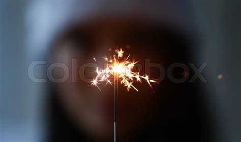 Woman hold sparklers in hand closeup. ... | Stock image | Colourbox