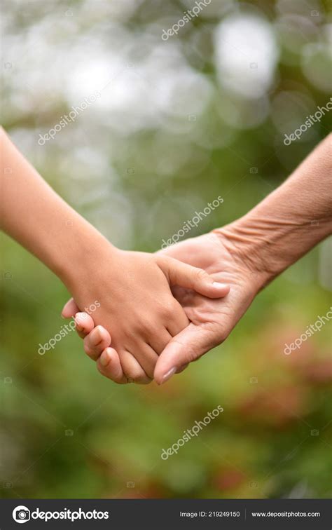 Two People Holding Hands Nature Stock Photo by ©aletia 219249150