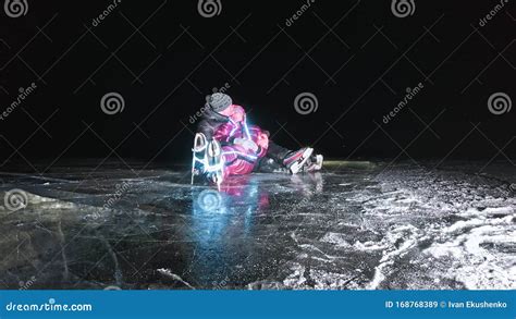 Young Loving Couple Skating at Ice Rink at Night. Man and Woman Kiss ...