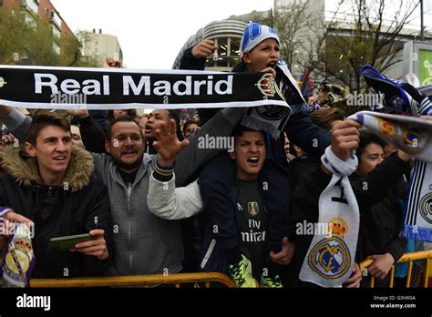 Real Madrid fans cheer as the players arrive at the Santiago Bernabeu stadium before the UEFA ...