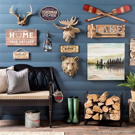 a living room filled with furniture and lots of wall art hanging on the ...
