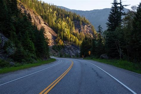 Premium Photo | Windy scenic road around the mountains during a vibrant ...