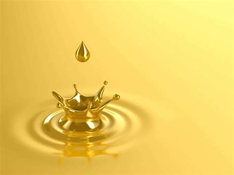 Download A Golden Drop Of Oil Is Falling Into Water | Wallpapers.com