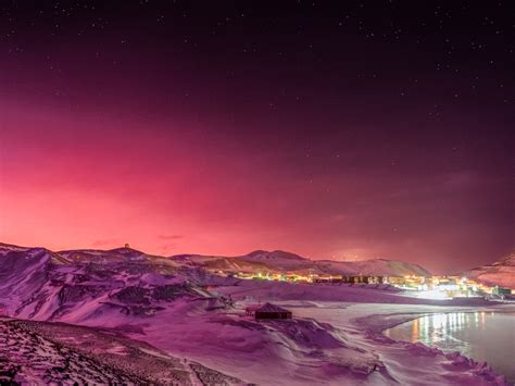 Amazing photo shows Antarctica bathed in pink light after a volcano eruption spewed particles in ...