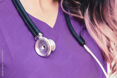 Closeup of a stethoscope on a female nurse in a purple uniform Stock Photo | Adobe Stock