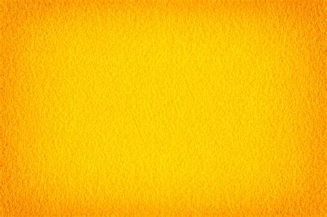 Premium Photo | Abstract background with bright yellow felt. High resolution photo. vignette