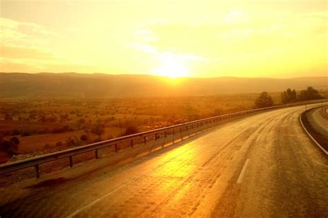 Premium Photo | Beautiful golden sunrise over the road