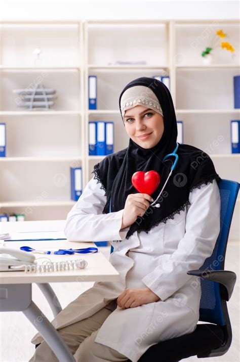 Young Doctor In Hijab Working In The Clinic Photo Background And ...