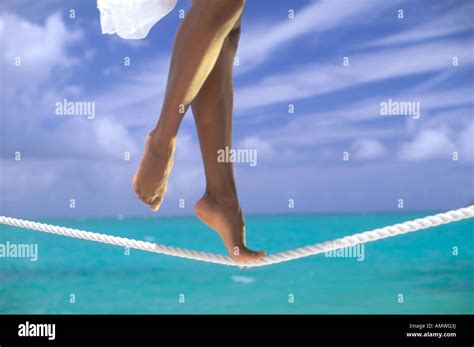 USA, Hawaiian Islands. Woman tightrope walking ocean side Stock Photo - Alamy