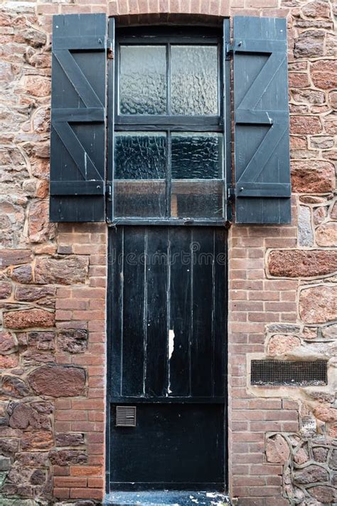 Black Painted Wooden Storm Shutters Over a Victorian Warehouse Window Stock Image - Image of ...