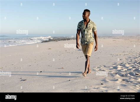 Man walking on beach hi-res stock photography and images - Alamy