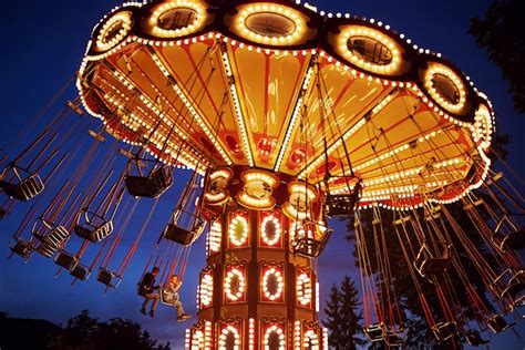 Premium Photo | Carousel merry-go-round in amusement park at night city