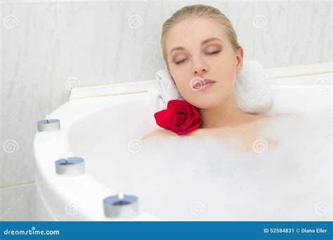 Beautiful Woman Relaxing In Bath With Flower And Candles Stock Photo - Image: 52584831