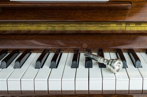 Trumpet Mouthpiece upon the Piano Keys, Close Up Stock Image - Image of book, instrument: 72451971