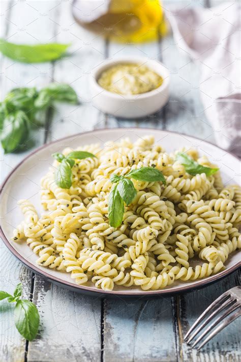 Italian fusilli pasta with pesto containing pasta, pesto, and basil | Food Images ~ Creative Market