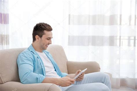 Young man resting on couch — Stock Photo © belchonock #147485197