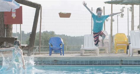 Slow motion shot of young kids jumping to a swimming pool Stock Video ...