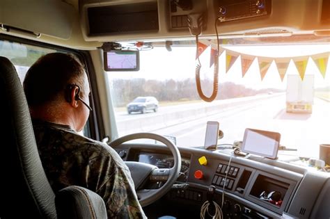 Premium Photo | Driver in cabin of big modern truck