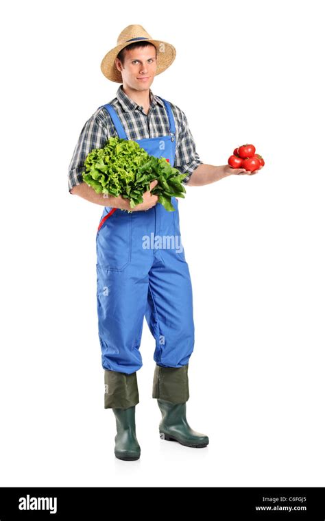 Full length portrait of a male farmer holding vegetables Stock Photo ...