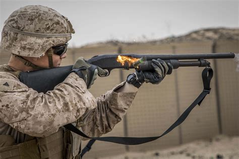 A Marine fires a Mossberg 590A1 12-gauge shotgun during a nonlethal ...