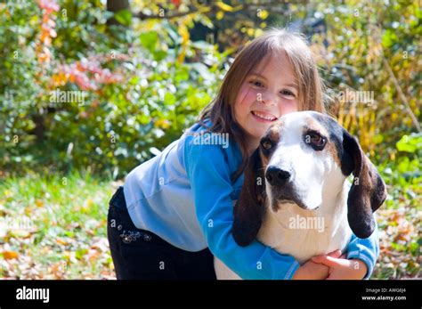 Little girl giving her hound dog a big hug Stock Photo - Alamy