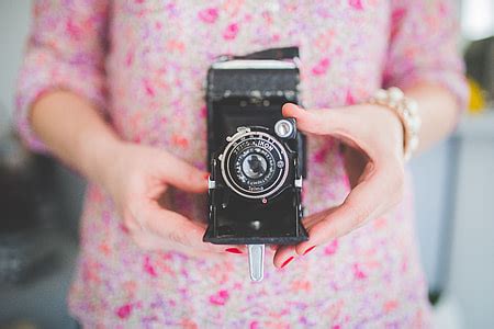 Royalty-Free photo: Black and Gray Film Camera on Green Floral Textile | PickPik