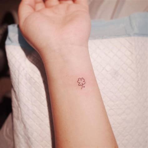 Tiny clover tattoo on the wrist.