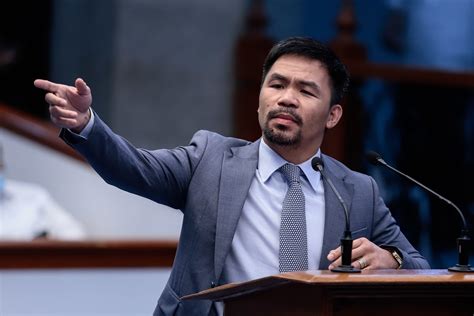 Manny Pacquiao wearing a grey suit while giving a speech at the Senate