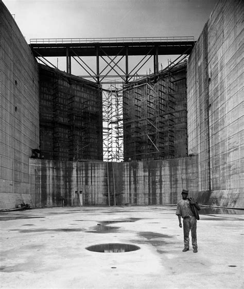 Panama Canal Construction - A worker stands in one of the canal locks, 1912 (Photo: Bettmann ...