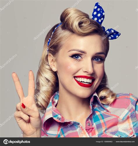 Woman, showing two fingers or victory gesture, dressed in pin-up — Stock Photo © g_studio #156889962