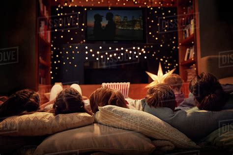 Family Enjoying Movie Night At Home Together - Stock Photo - Dissolve