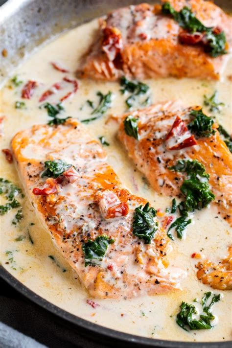 Tender salmon filets smothered in a rich garlic cream sauce filled with ...