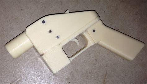 3D-printed Liberator pistol, single shot. Its barrel in epoxy can take .380 and .45 ammunition.