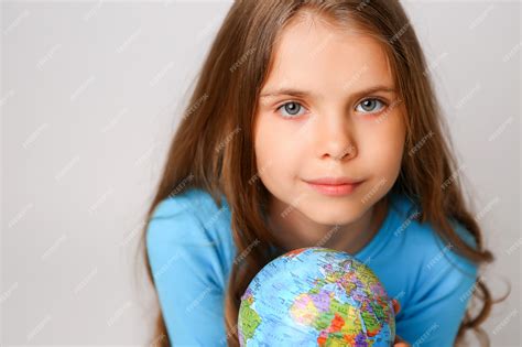 Premium Photo | Preteen girl holding an earth globe