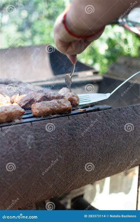 Mititei. Turn the Mititei on the Grill with a Fork Stock Photo - Image ...