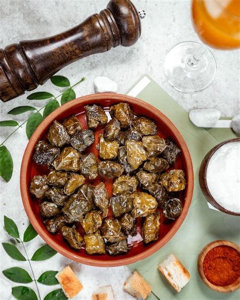 Free Photo | Top view of azerbaijan grape leaves dolma in pottery pan served with yogurt