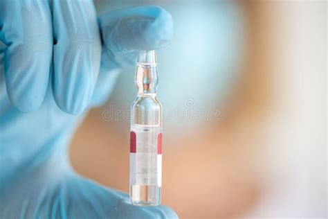 Medicine Ampoule for Injection in Nurse Hand. Medical Glass Vial for Vaccination. Science ...