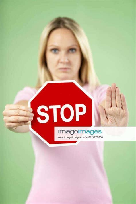 Woman Holding Road Traffic Sign model released, Symbolfotoproperty released