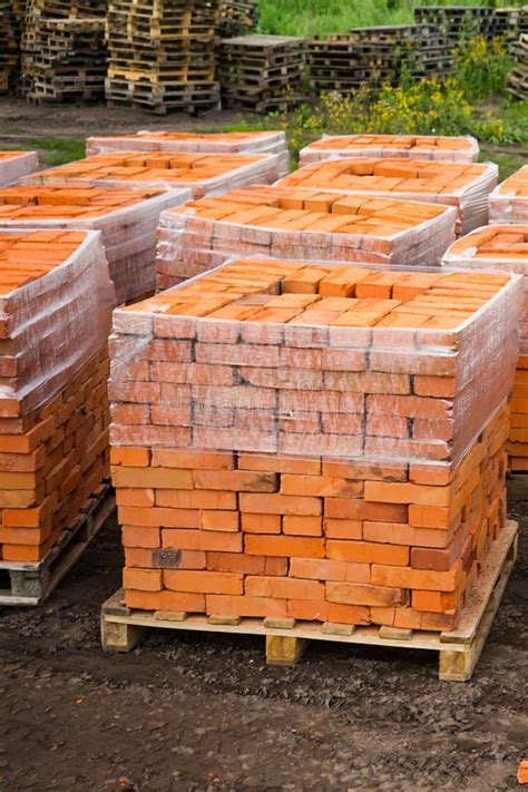 Red Clay Bricks are Stacked on Wooden Pallets. Production of Bricks from Clay Stock Image ...