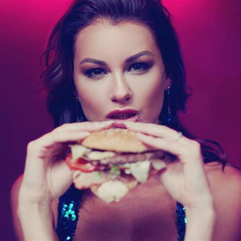 Gorgeous Woman Eating Hamburger in Night Club Stock Image - Image of kebab, party: 119562265