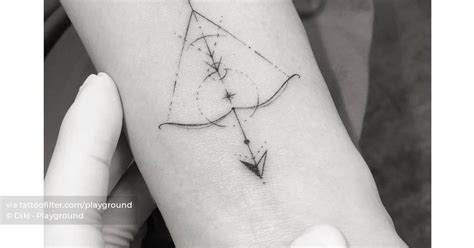 Fine line geometric bow and arrow tattoo located on the