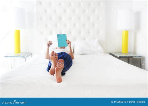 Young Man Reading Book in the Bed Stock Image - Image of looking ...